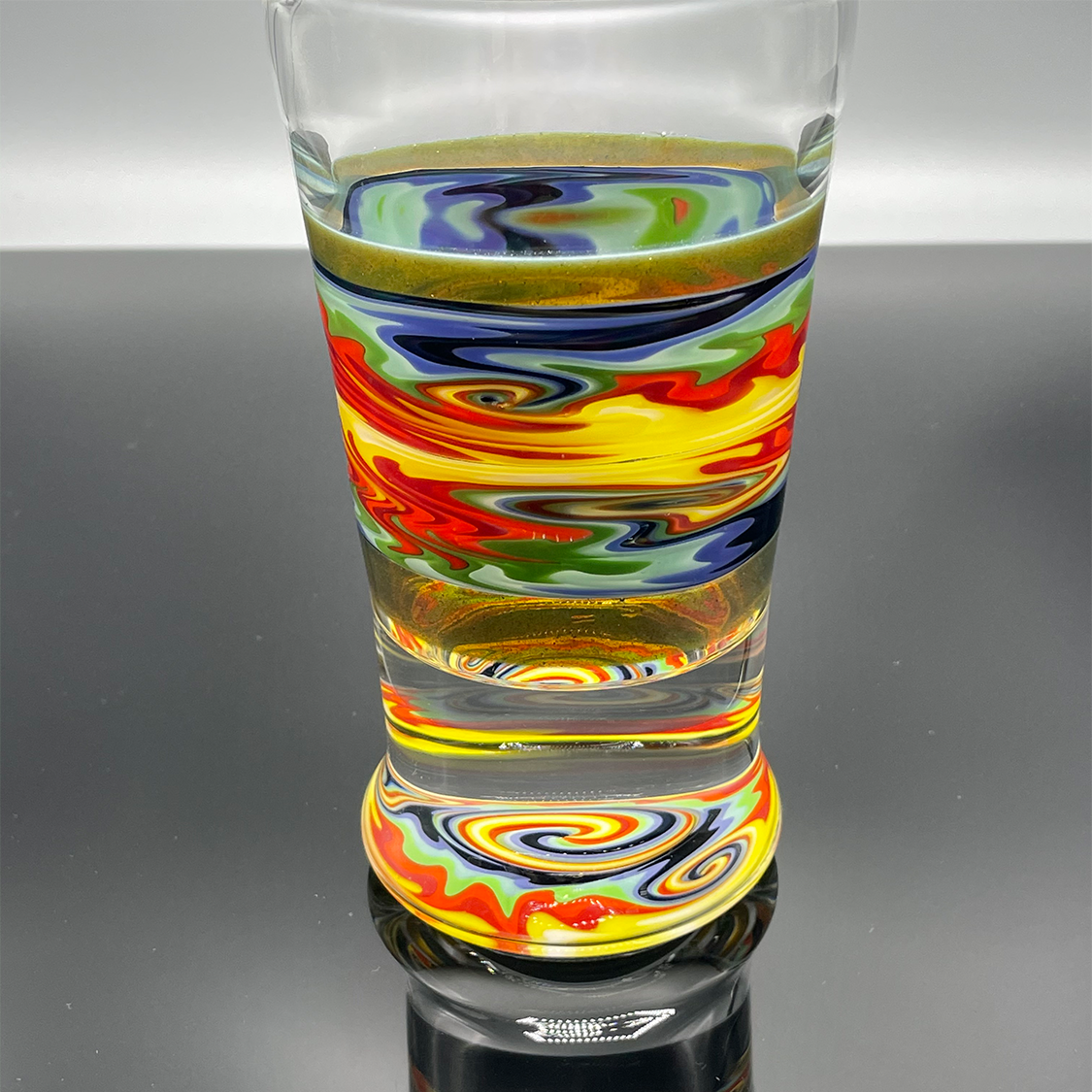 Multi-color beer glass with colored sections on the wall and bottom